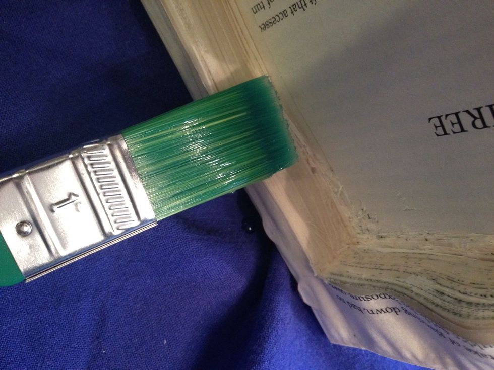 Now paint the sides of the secret hole with the glue solution. Also paint the top of the page where you measured originally.