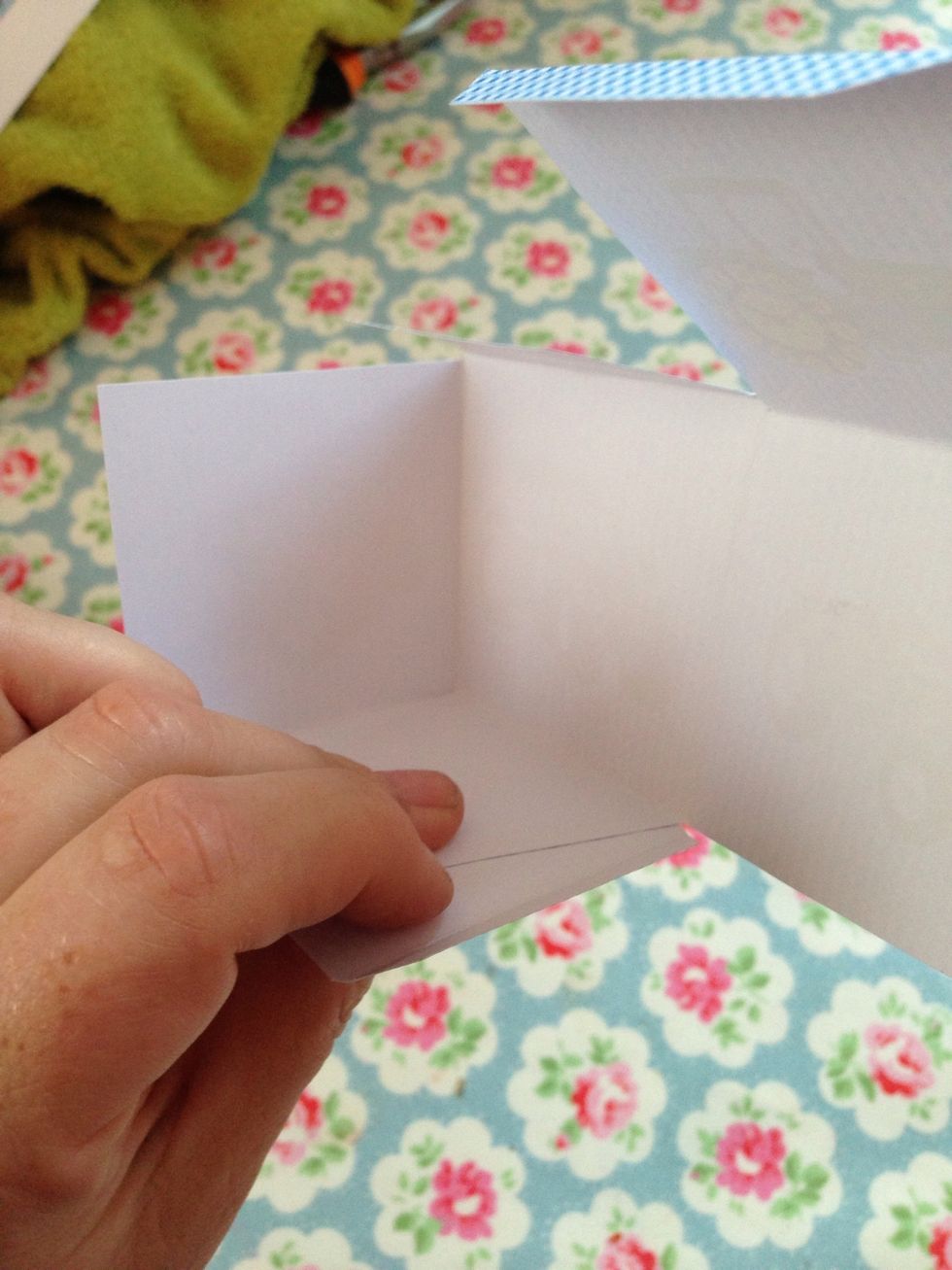 Now pick the box up and stick the first large tab to the base.