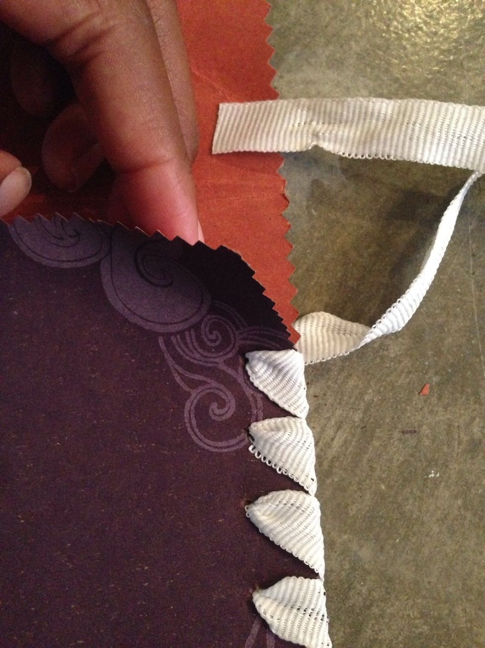 Now pierce only the top layer of paper. Thread ribbon through.