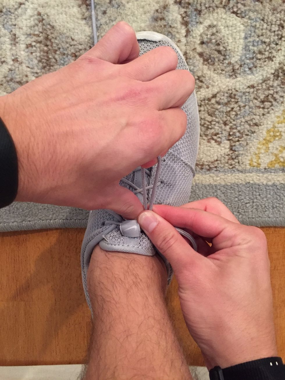 Now, pinch with your right thumb and index finger to hold the "loop" while your left then continues to hold the "crossed over" section of the laces