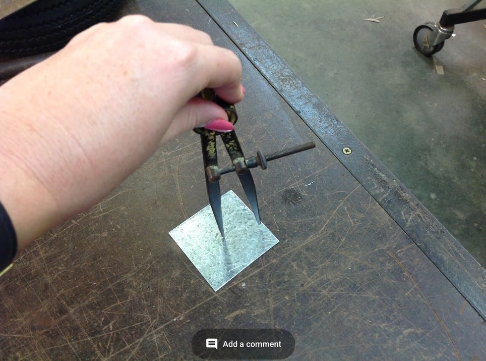 Now place one of the dividers legs in the indent and mark out a perfect circle.