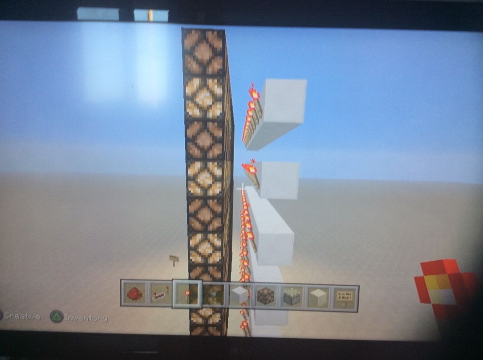 Now place redstone torches on the blocks facing the redstone lamps.