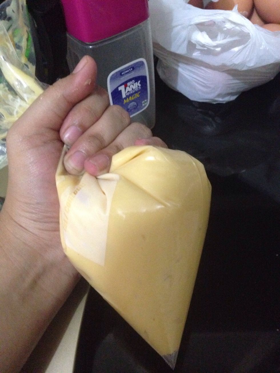 Now place the dough in piping bag. I run out of piping bag, so I place it in ziplock bag then I cut the corner to make opening