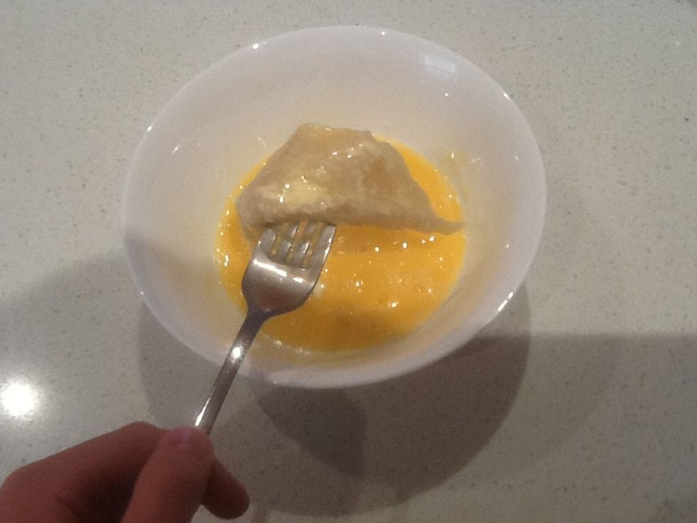Now place the fillet into the whisked egg