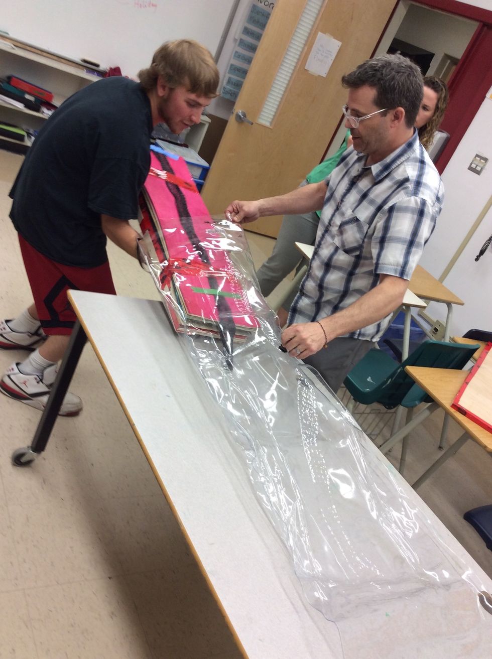 Now place your board inside the bag gently, try not to pinch or damage the bag while putting it in, also watch the pump valve so that it doesn't get damaged either.