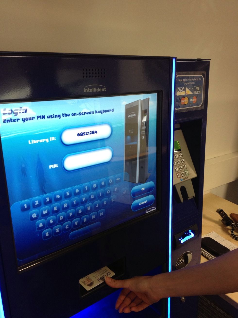 Now place your Brunel ID card in the reader below the screen. It can go in any way, but needs to touch the base of the reader. Once your card number shows on screen you can remove your card.