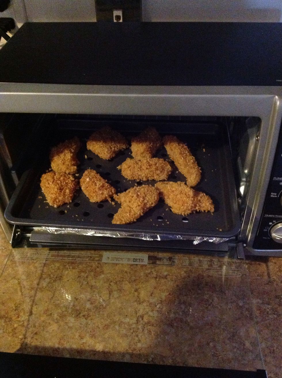 Now place your chicken nuggets into the oven on a cookie sheet and if you have a wire rack place it over(This makes them extra crispy) At 450 degrees bake each side at 6 mins for total of 12 mins.