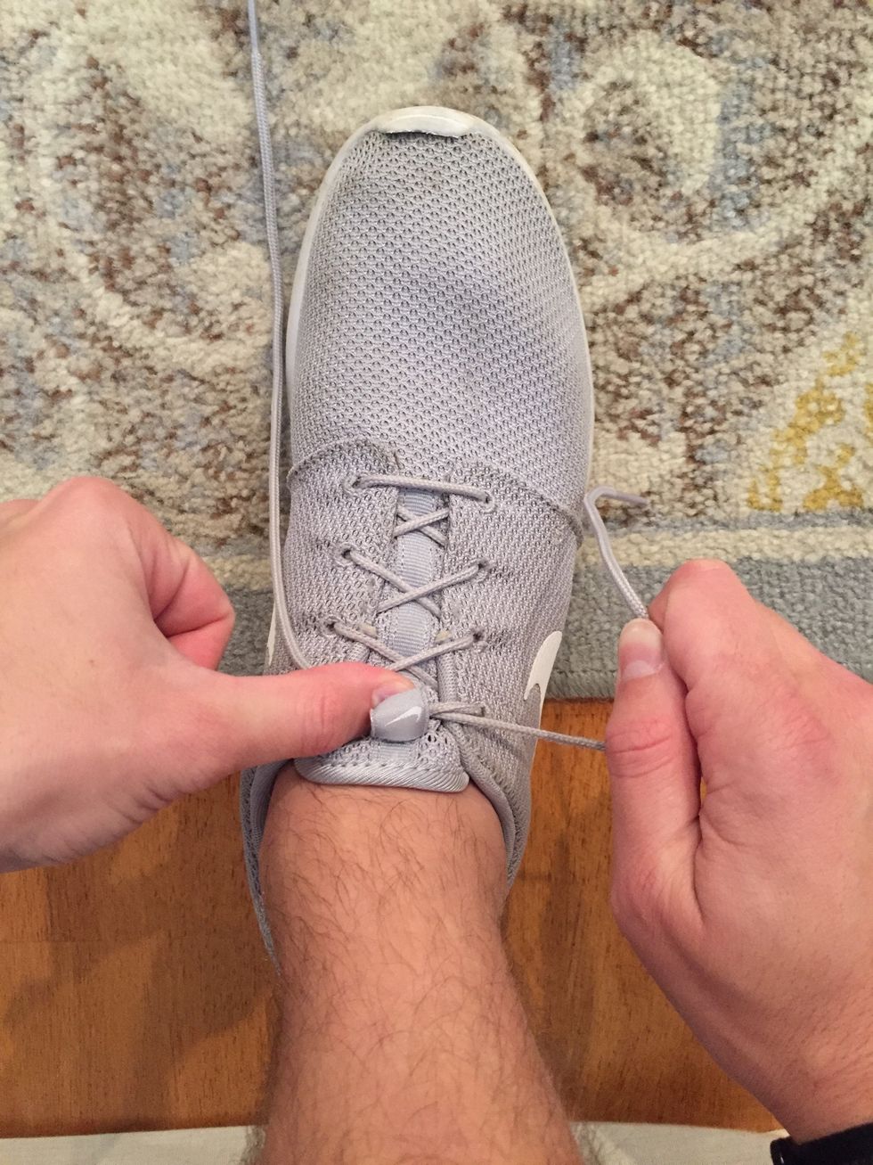 Now, place your thumb on the "crossed over" section in order to hold it in place to keep it tight