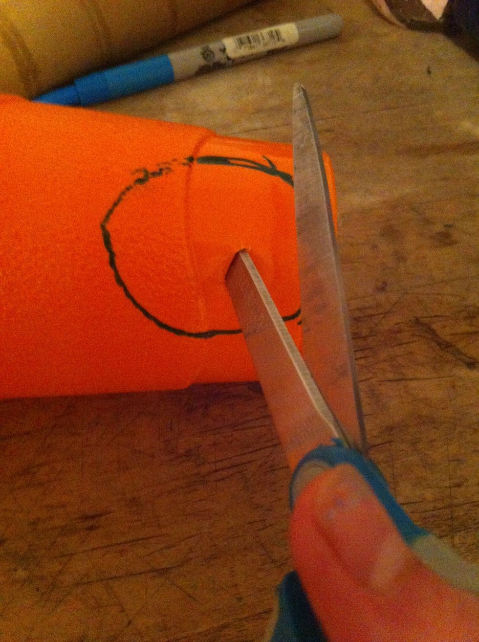 Now poke a hole in the center of your circle with your scissors