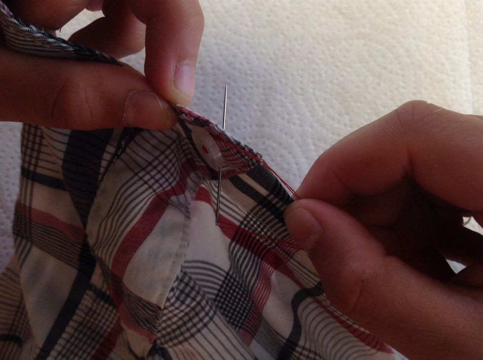 Now poke the needle and the tightly wrapped thread back down through the material, pulling the thread taut.