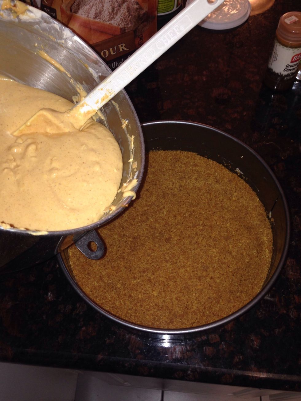 Now Pour cheese cake batter into prepared spring form pan with the set graham cracker crust.