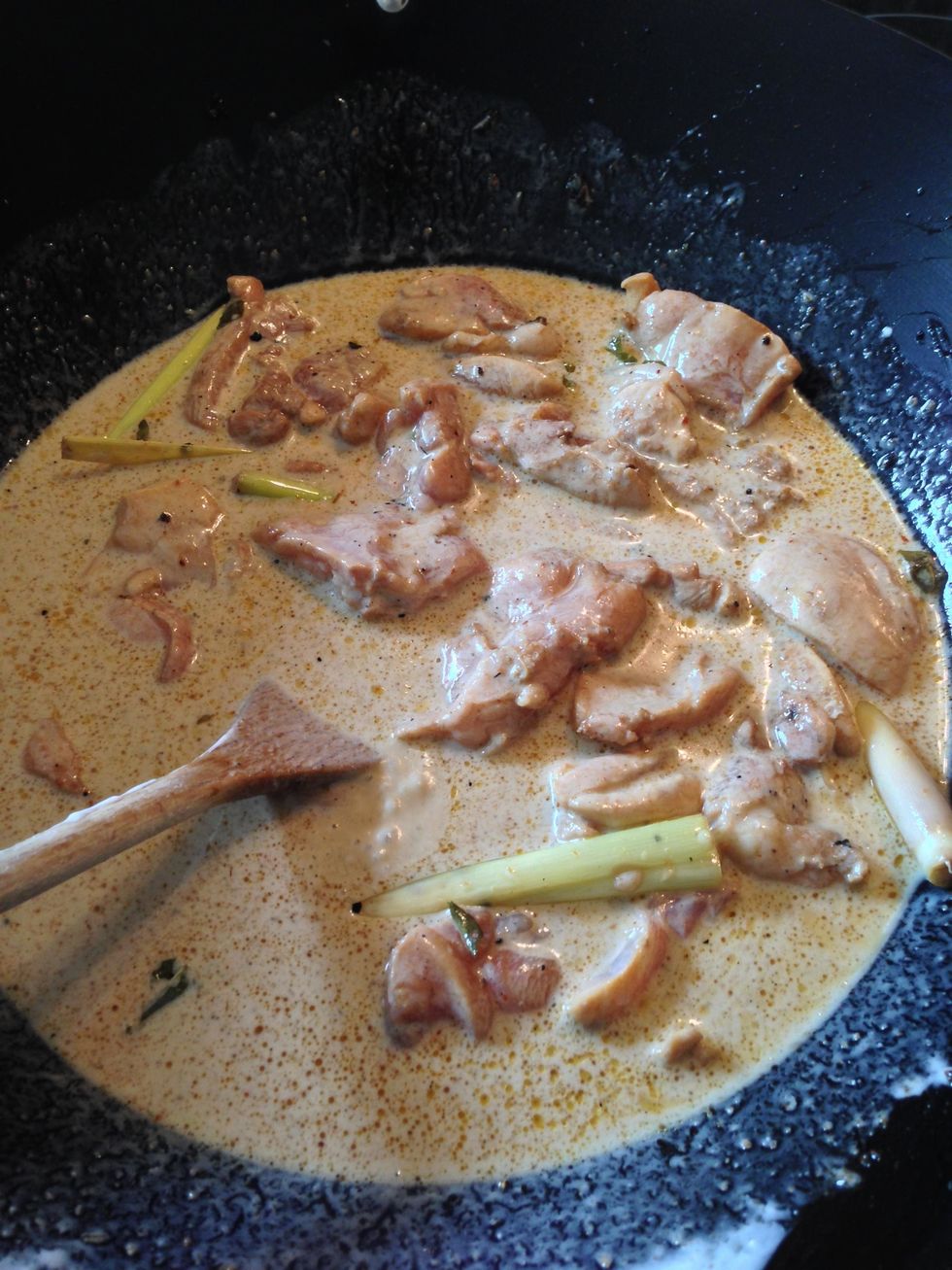 Now pour the Coconut milk into the wok, and give it a few dashes of Light Soy Sauce. Reduce the heat and leave for around 25 minutes. Stir it from time to time.