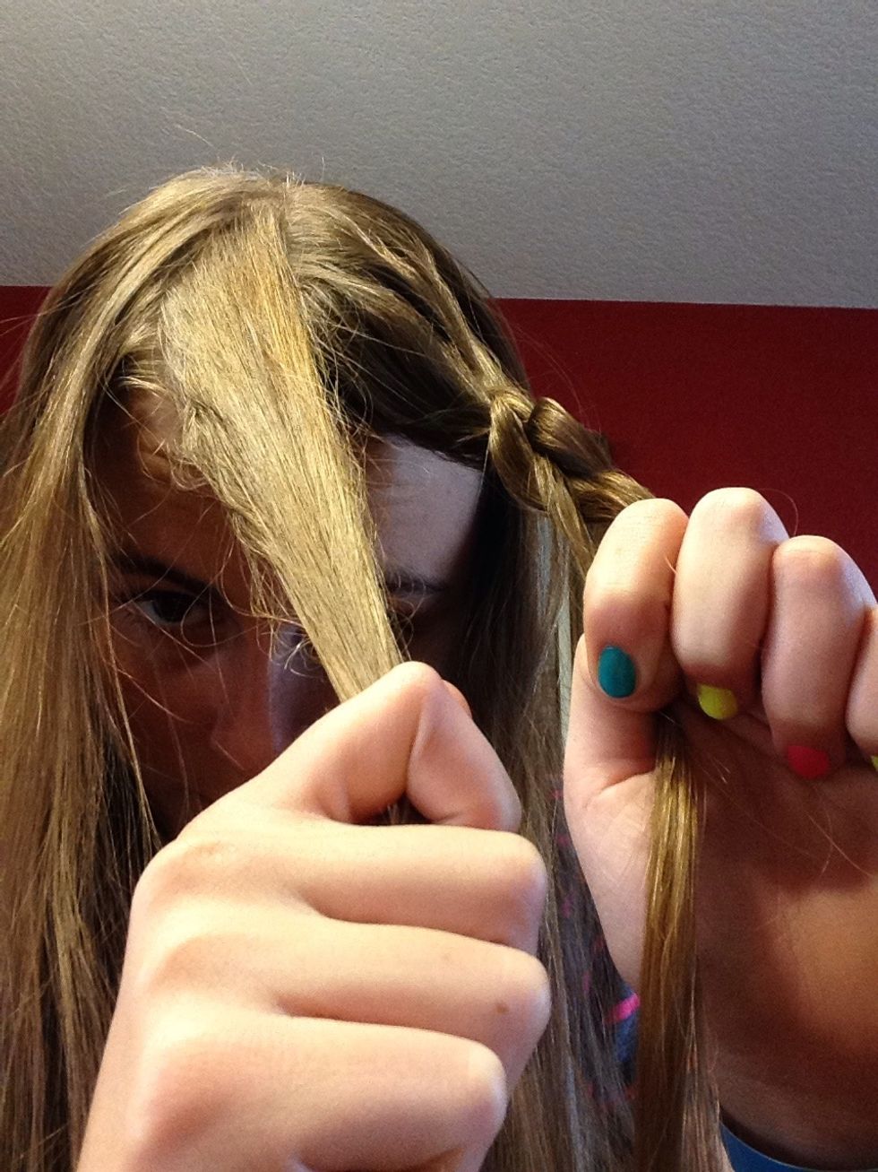 Now pull a small piece of hair from the other side of the part.