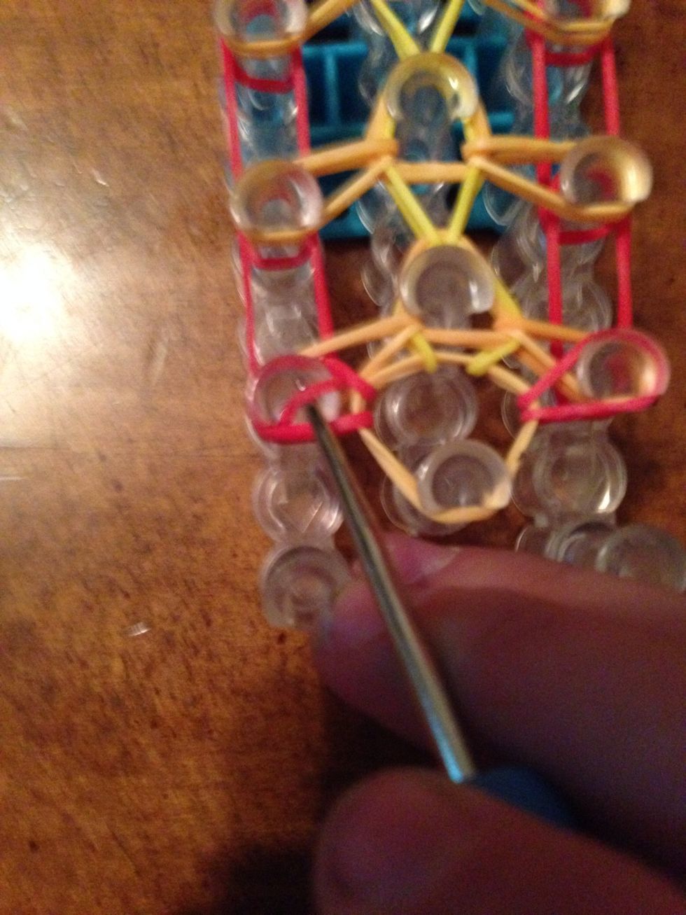 Now pull everything back and pull over the bottom rubber band