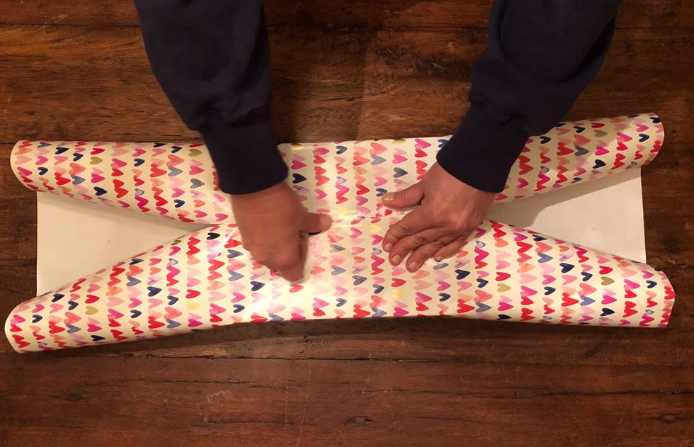 Now pull the paper on the other side to the middle of the present and secure with tape.