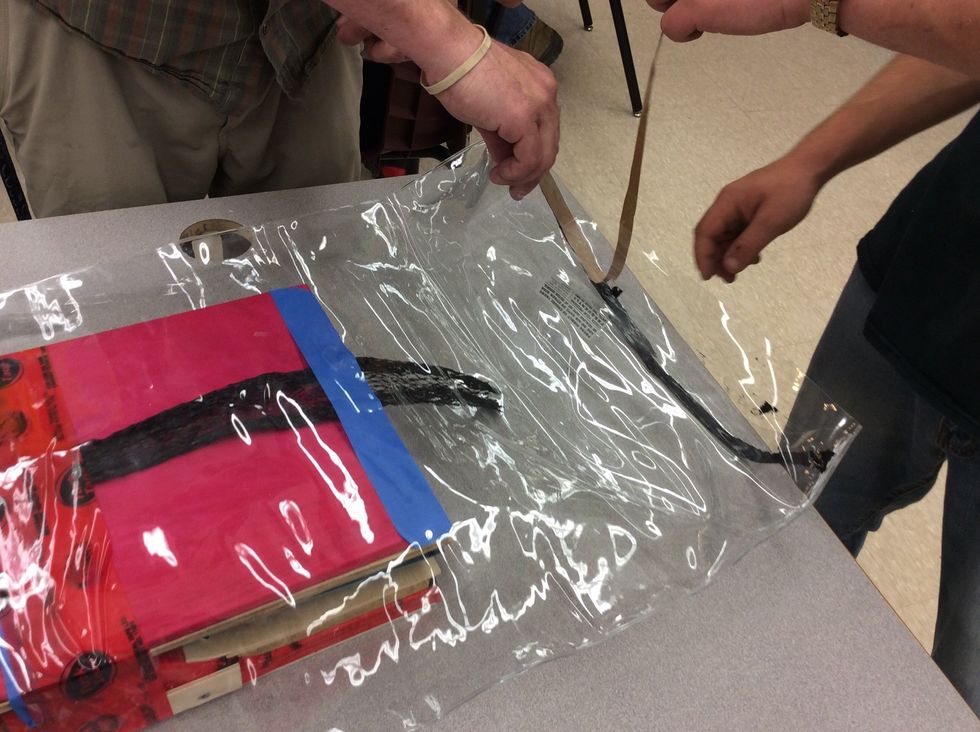 Now put a tar strip at the front of the bag to keep it's seal. Make sure that you put your tar strip inside your bag before you seal it.