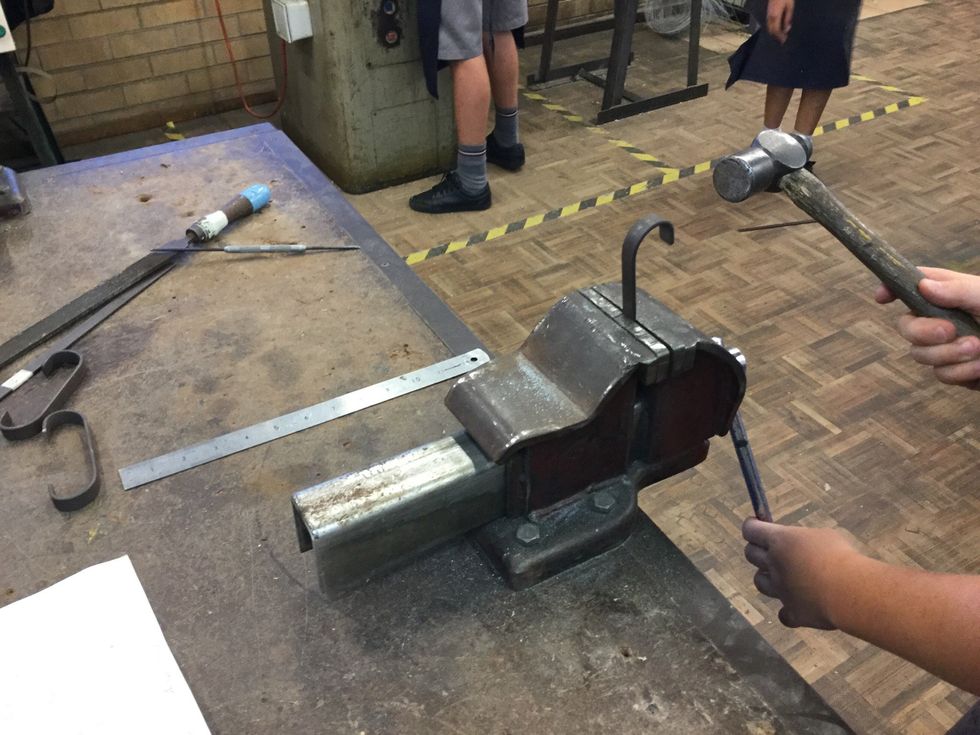 Now put it in the vice and use the ball pein hammer to bend the metal
