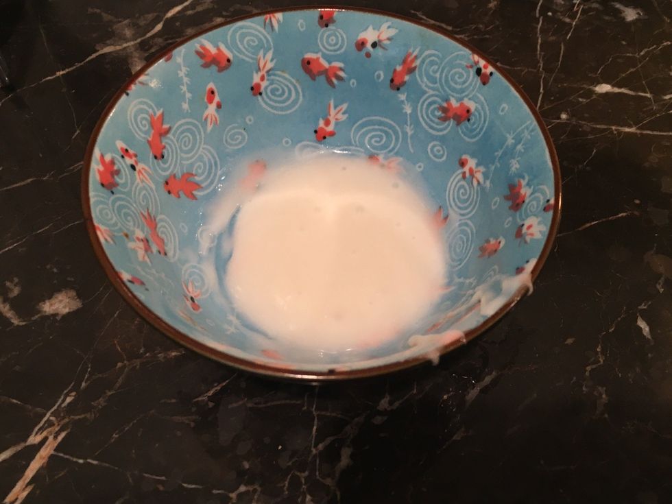 Now put one tablespoon frosting in a bowl with half a teaspoon of water. Now stir until smooth and set aside.