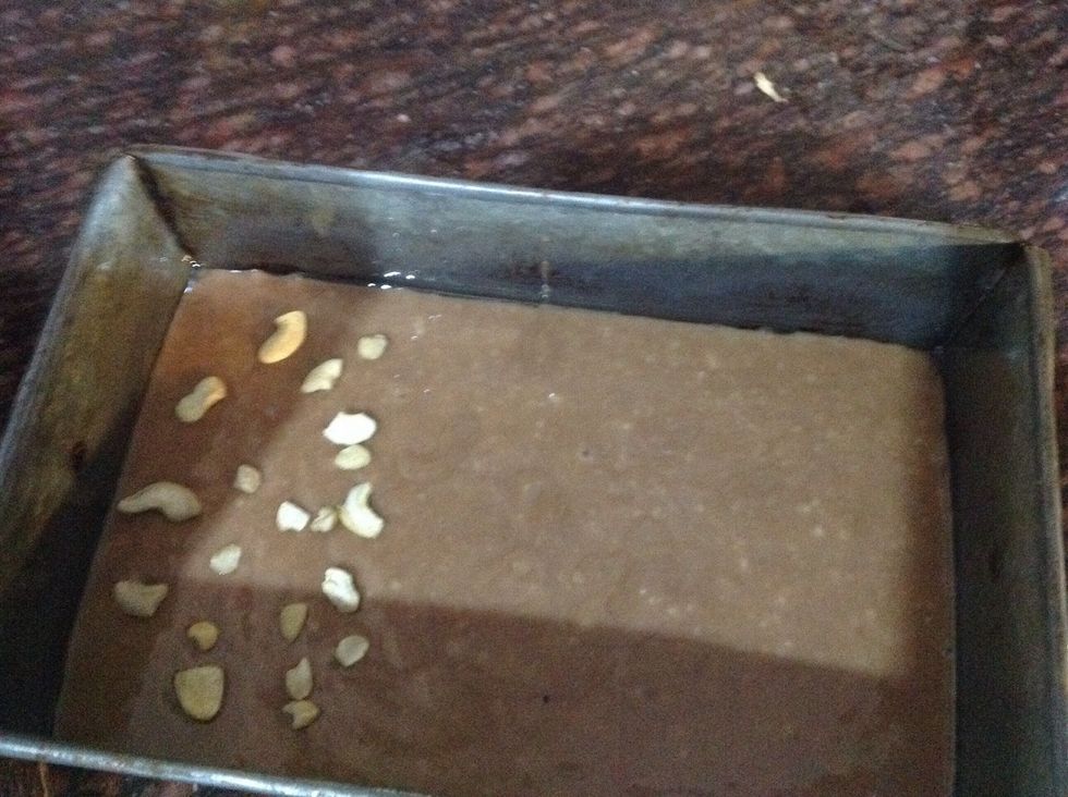 Now put the batter into a tin And don't forget to grease the tin with oil