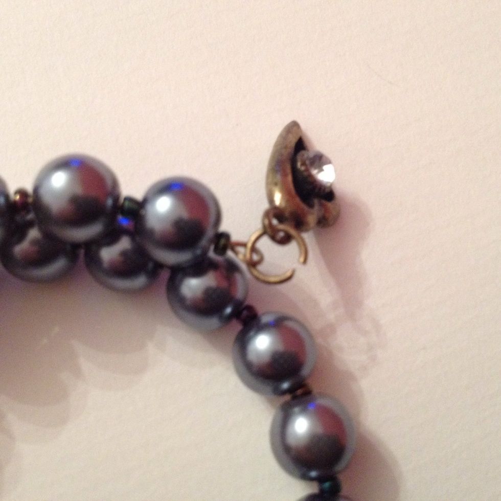 Now put the jump ring through one of the loops that we created on the bracelet.