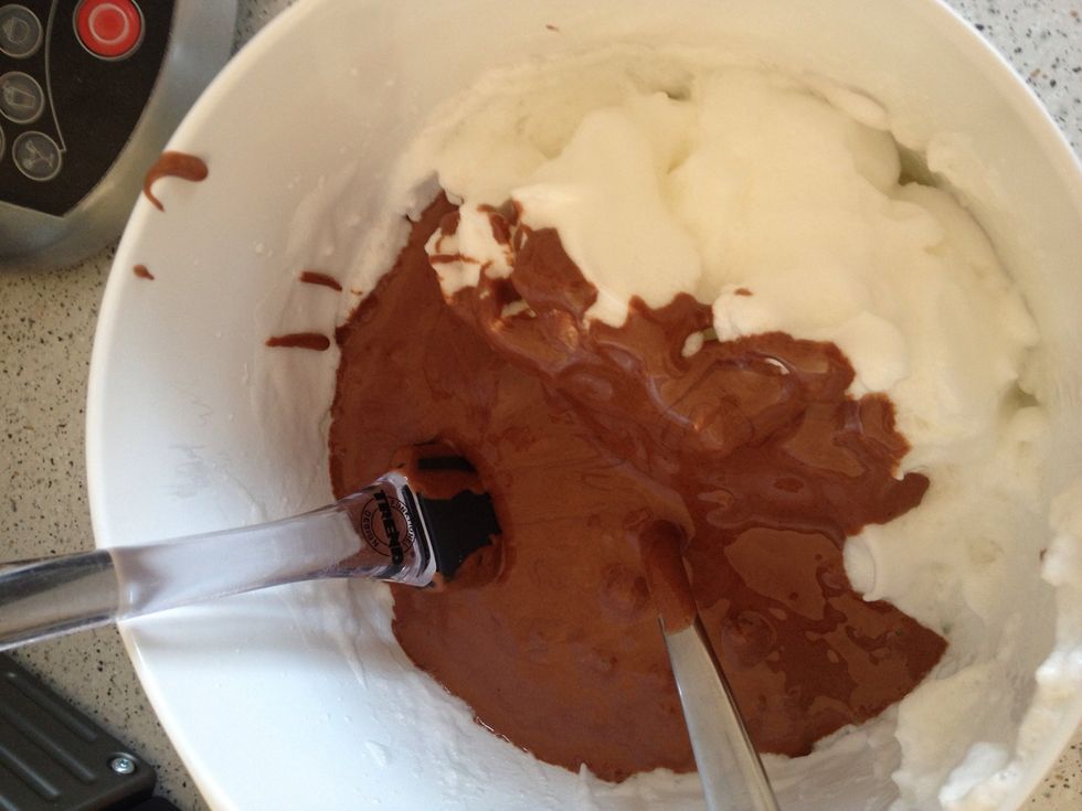 Now put the mixture into the rest of the egg whites and take a spoon and mix very slowly