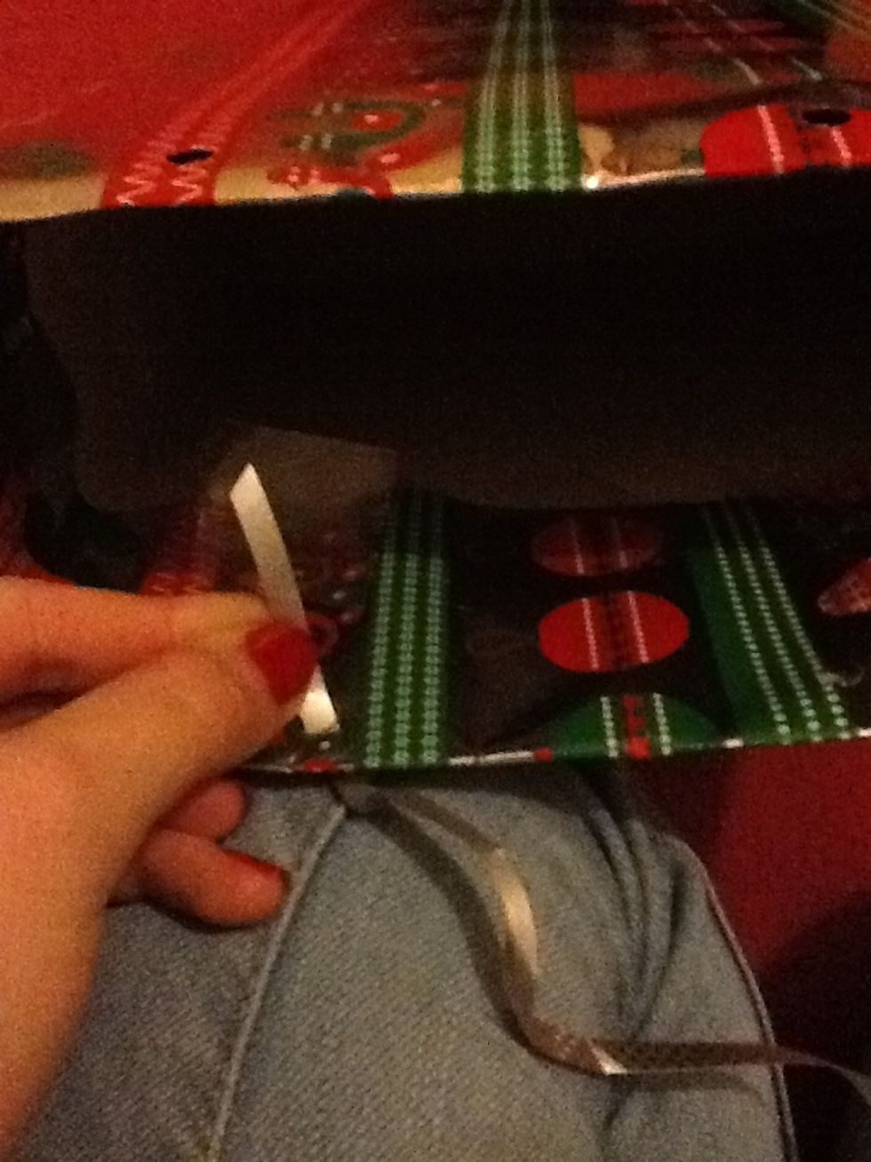 Now put the ribbon through the hole on the top of the bag and stick it down. Repeat this for each side and you should have some handles!