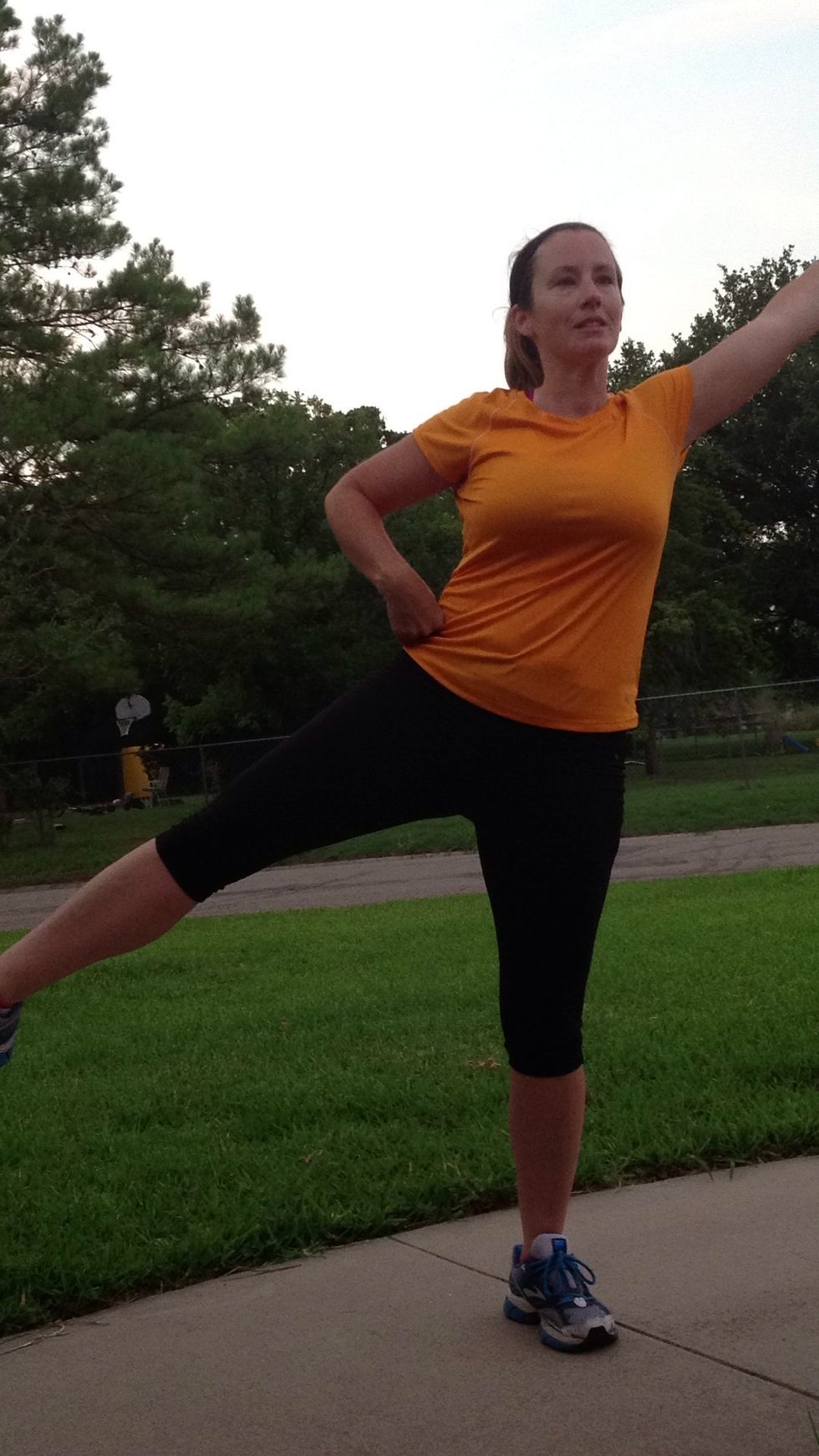 Now raise one leg straight off the ground at an angle. Raise opposite arm in air. Balance a second.