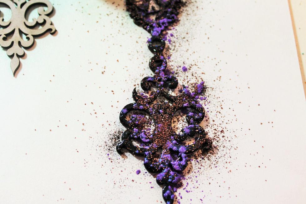 Now, randomly sprinkle mica powders and bronze embossing powders over the chipboard piece.