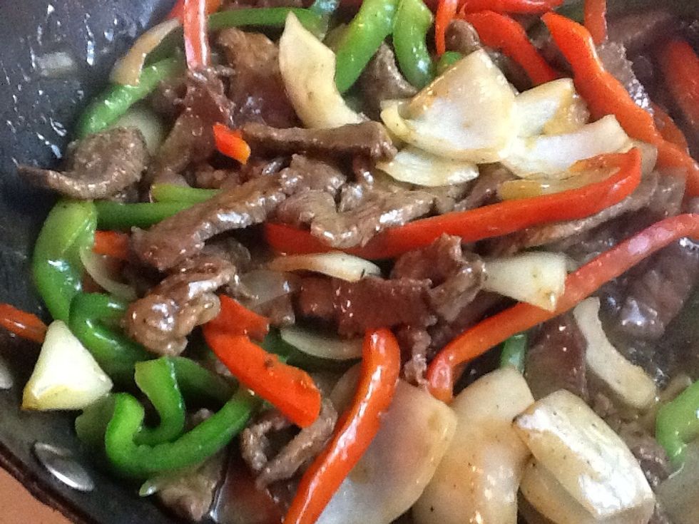 Now return the steak to the woks stir until the sauce has completely coated the steak and heated through.  Serve with white or brown rice.