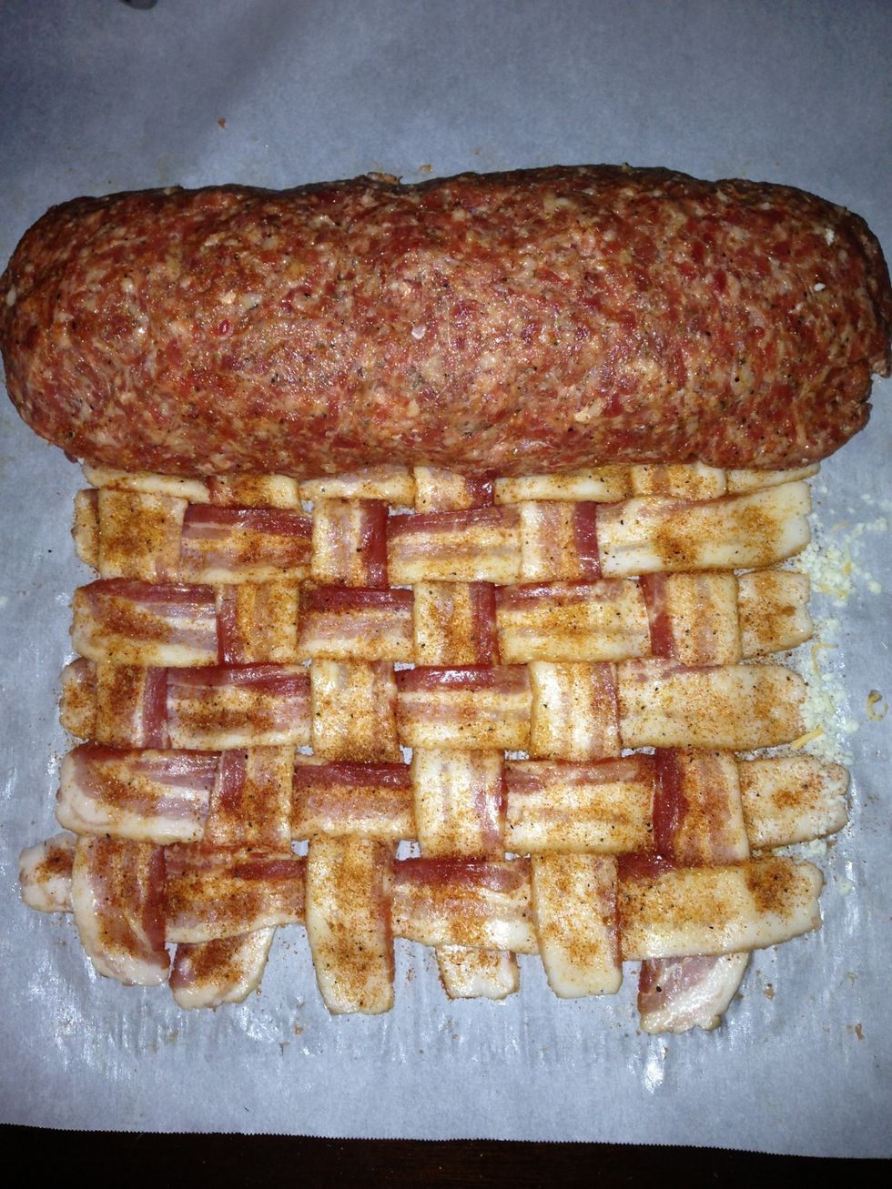 Now, roll up the sausage very tightly.  Leave the bacon weave behind.  Squeeze the ends of the sausage roll together so they are fully closed up.  Careful not to tear the sausage patty.