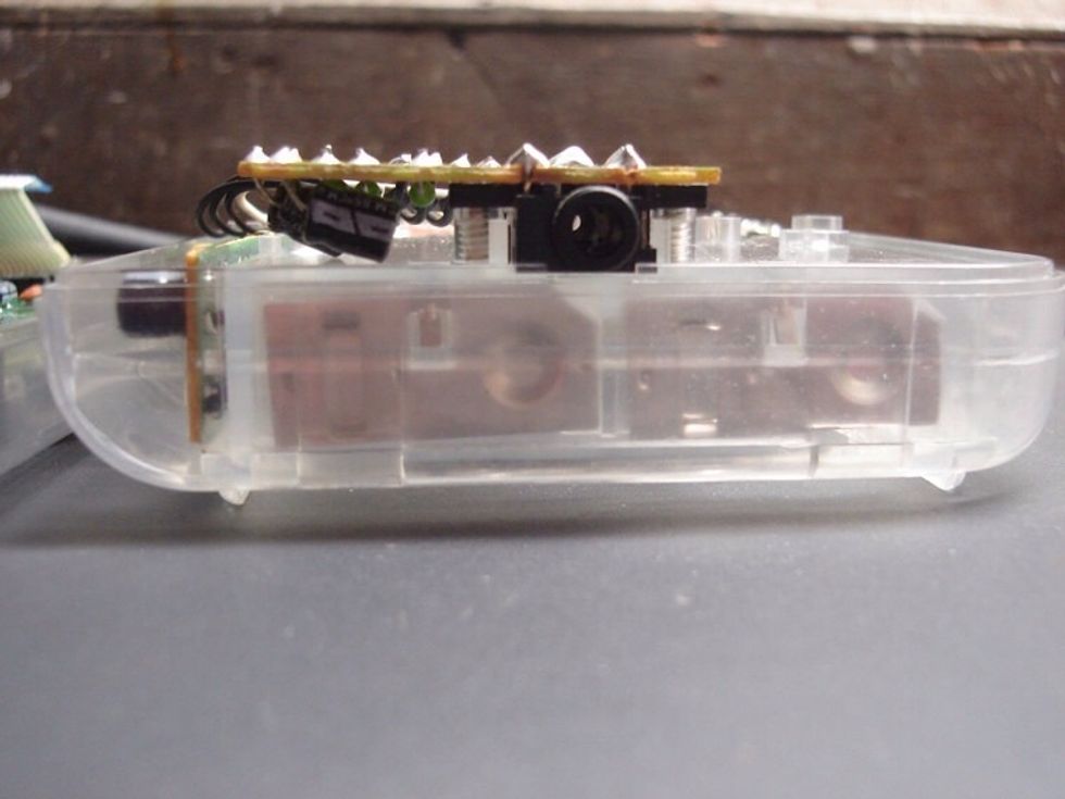 Now screw the board back into place. Make sure it still lays flush inside the case. Don't force it to fit, just carefully rebend the capacitor leads until it fits correctly.