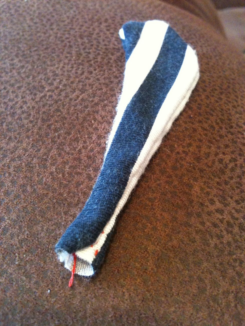 Now sew around all the open edges of the tail, just leaving the small end open! Now you need to stuff it with whatever you have, I'm using scraps from the fabric! Just stuff until it looks right.