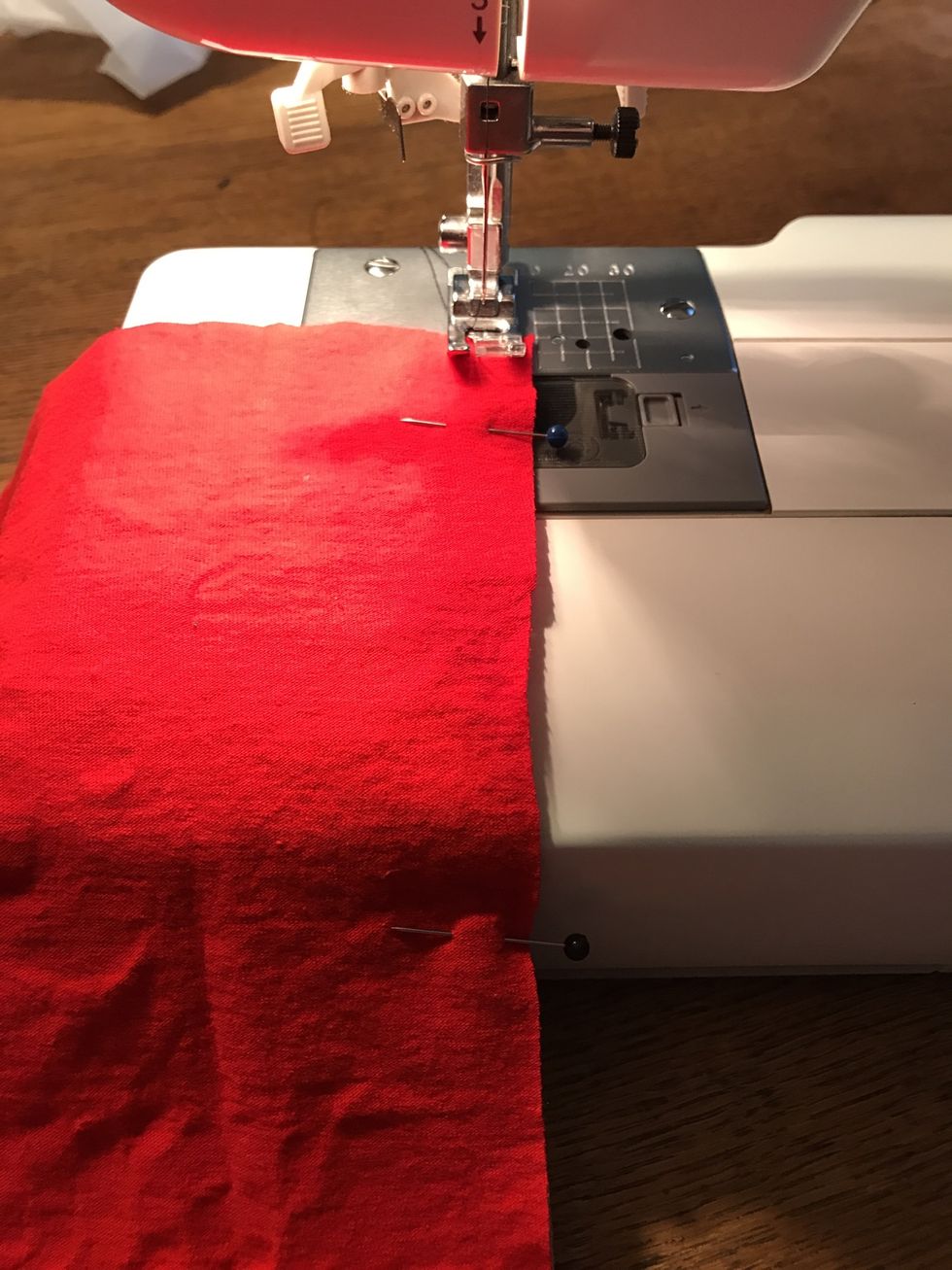 Now, sew the edges together. Keep the right side of the pressed foot lined up with the edge of the shirts. Backstitch at the top and bottom of the seam.