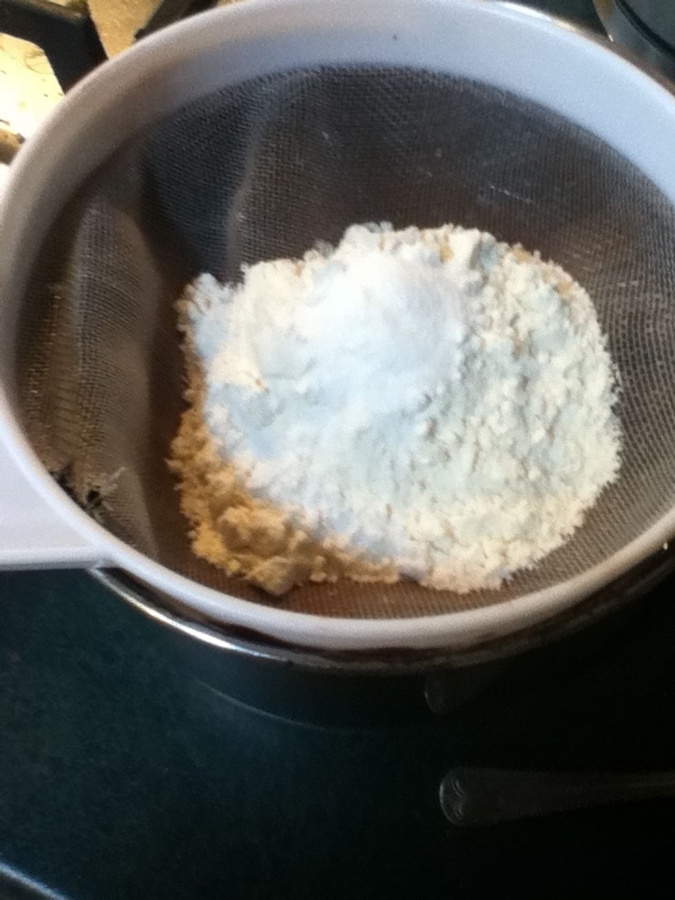 Now sieve the flour and baking soda over the mixture