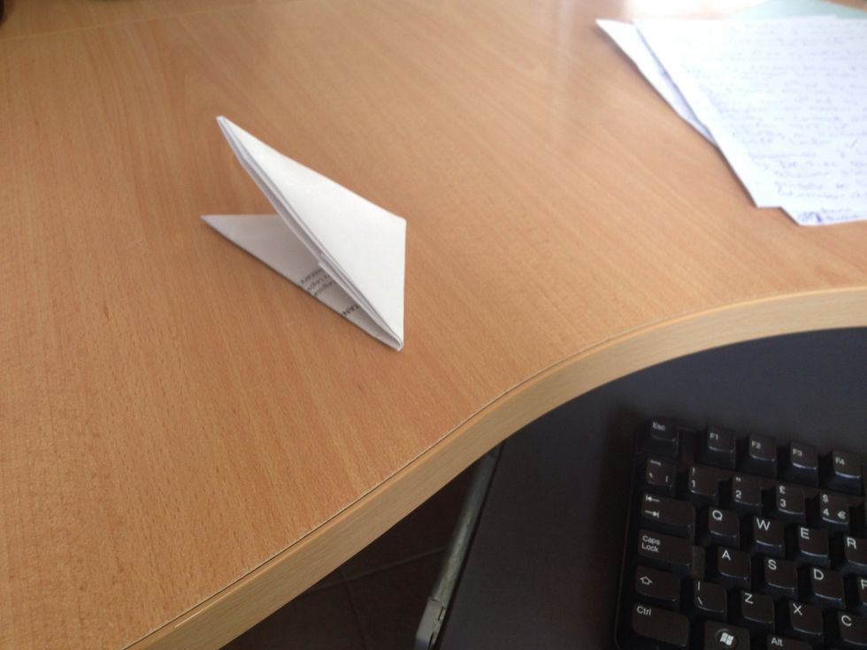 Now since its a complete triangle, fold it over in half to make a smaller triangle