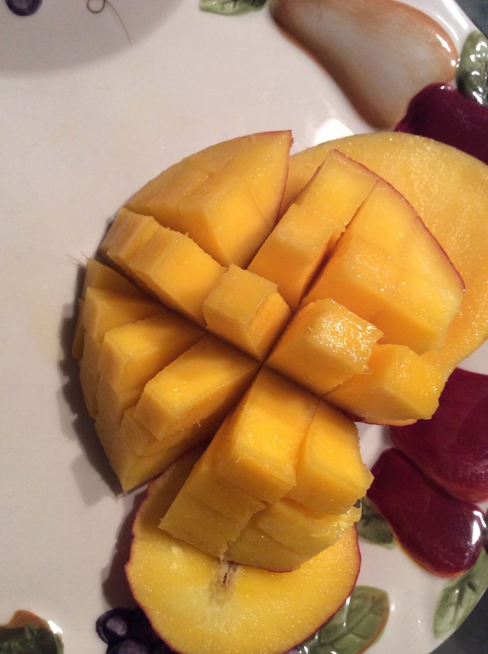 Now, slice it into chunks just like the pineapple and put it in the bowl.