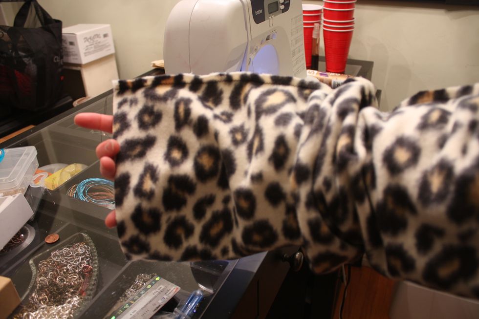 Now slip your hand inside and grab and edge. Pull half way through.