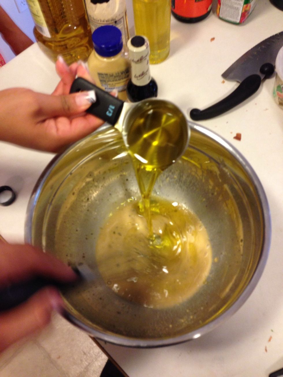 Now slowly add the olive oil while mixing like a mad person to emulsify the dressing and make the oil mix in well! Thanks to my wife for the help! :)