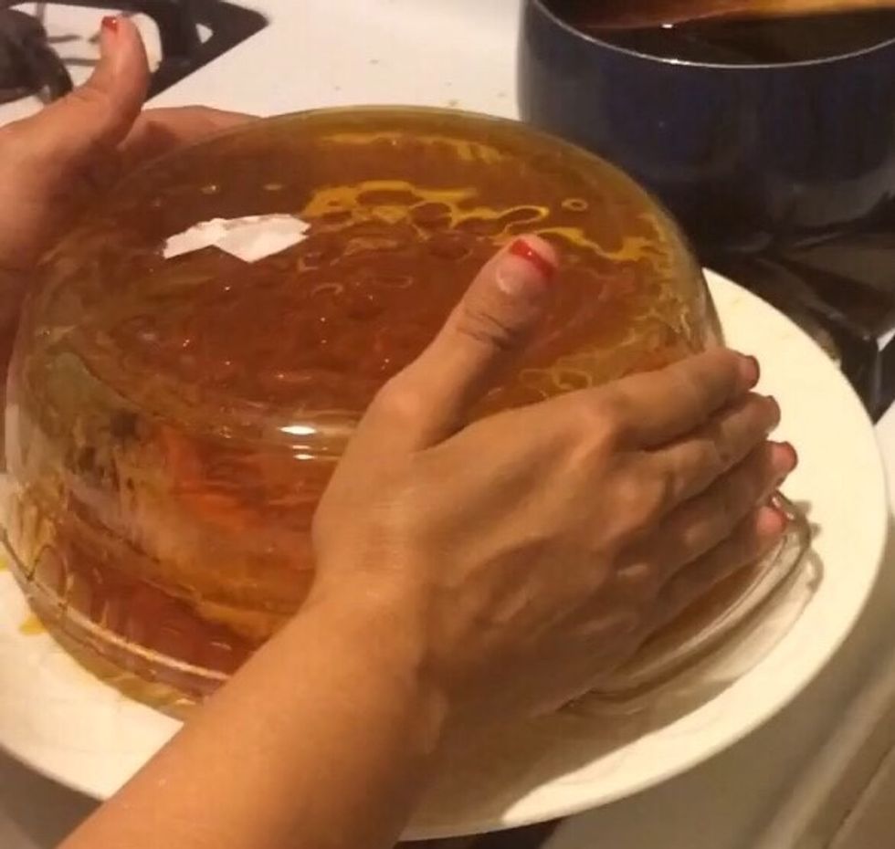 Now slowly remove the baking dish pulling upwards and ensuring the flan is staying on the plate. You may have to arrange the flan on the plate and clean up the sides.