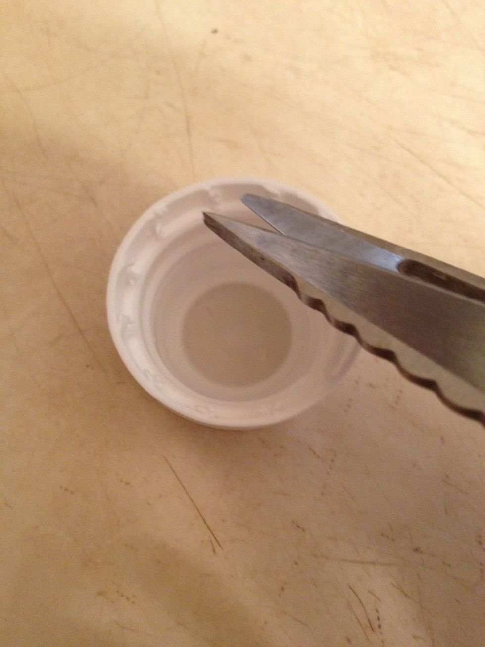Now so you can keep reusing this bottle, cut down the tabs inside the cap. I used scissors.