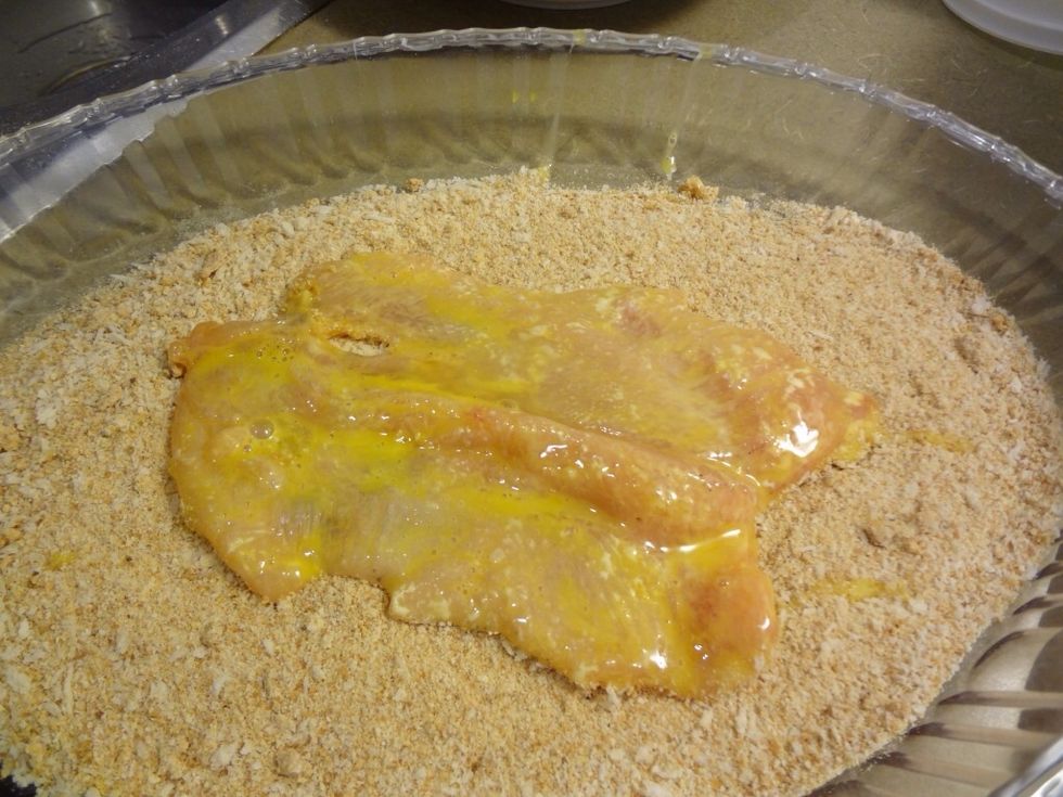 Now spread them over breadcrumbs. You can buy breadcrumbs from market or make them at home. Press in breadcrumbs gently and pat off excess.