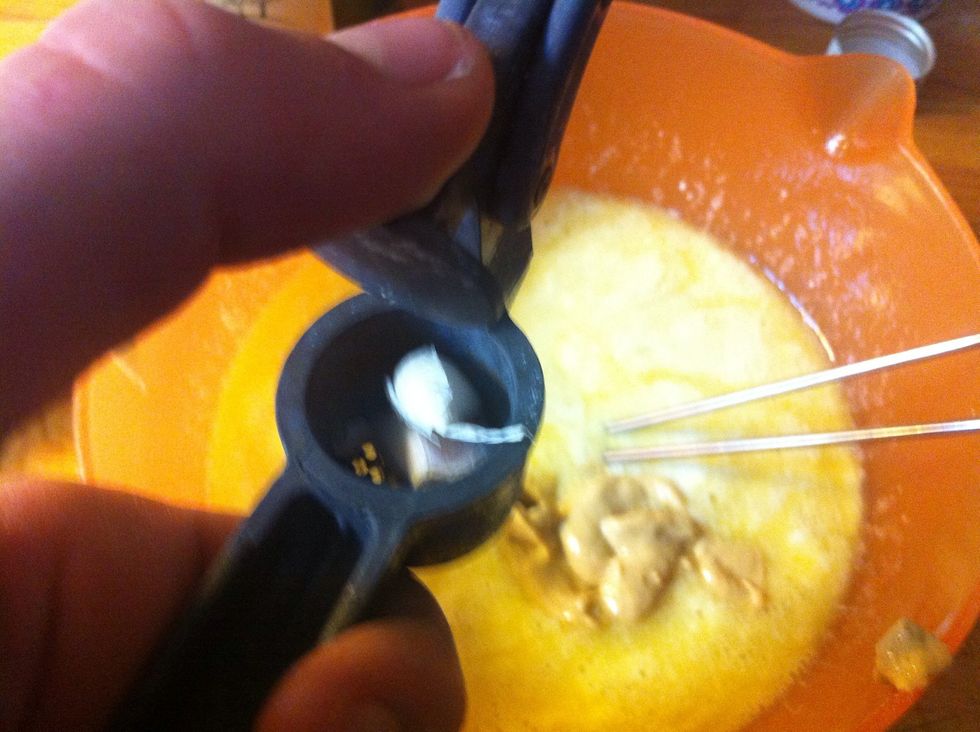 Now squeeze the clove of garlic.