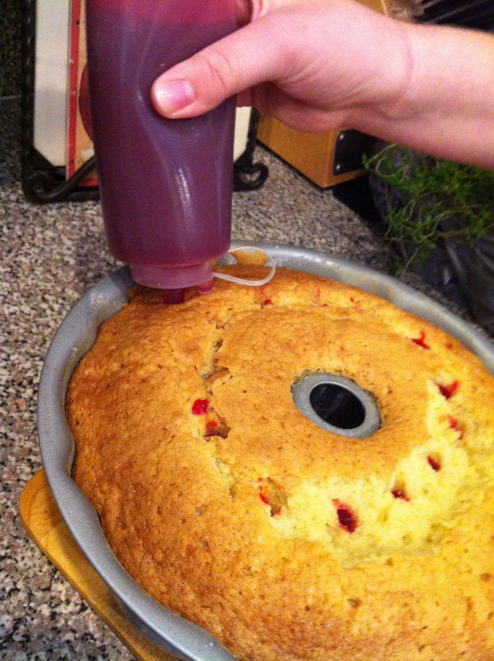 Now squeeze the syrup into the cake. I'm using a squeeze bottle for like ketchup or something but you could just poke it and pour some on. Don't use it all!!!!!!! I didn't even use a cup!
