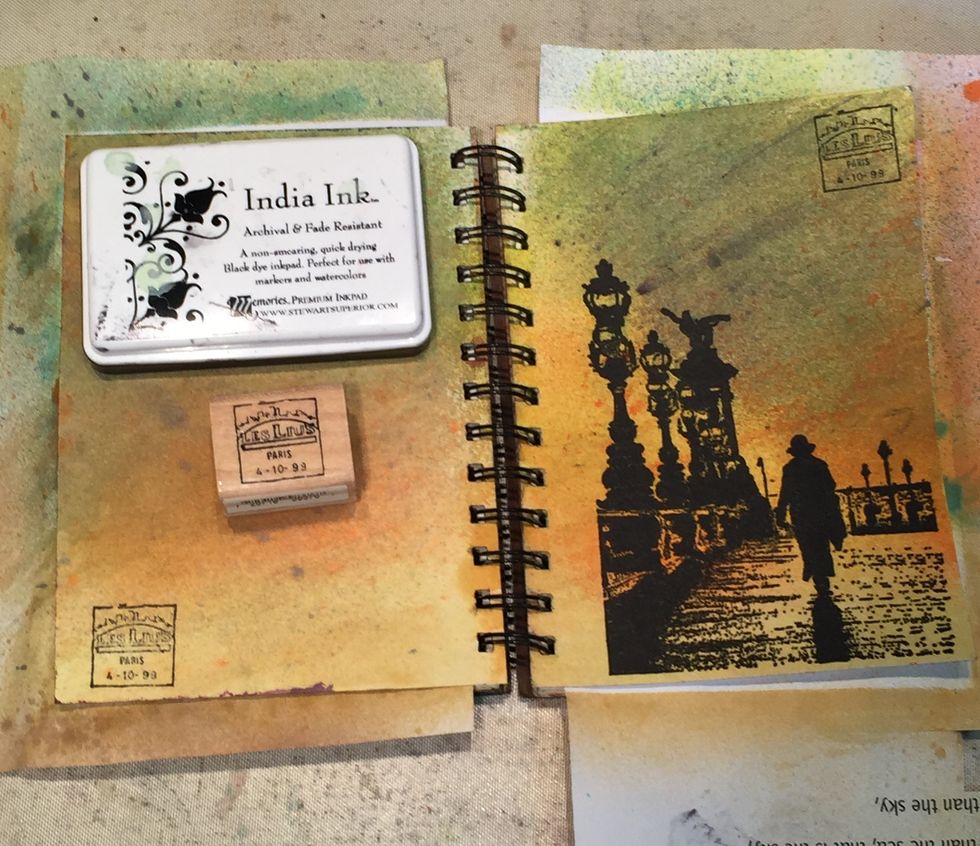 Now stamp both pages with a Paris postmark stamp and black ink.