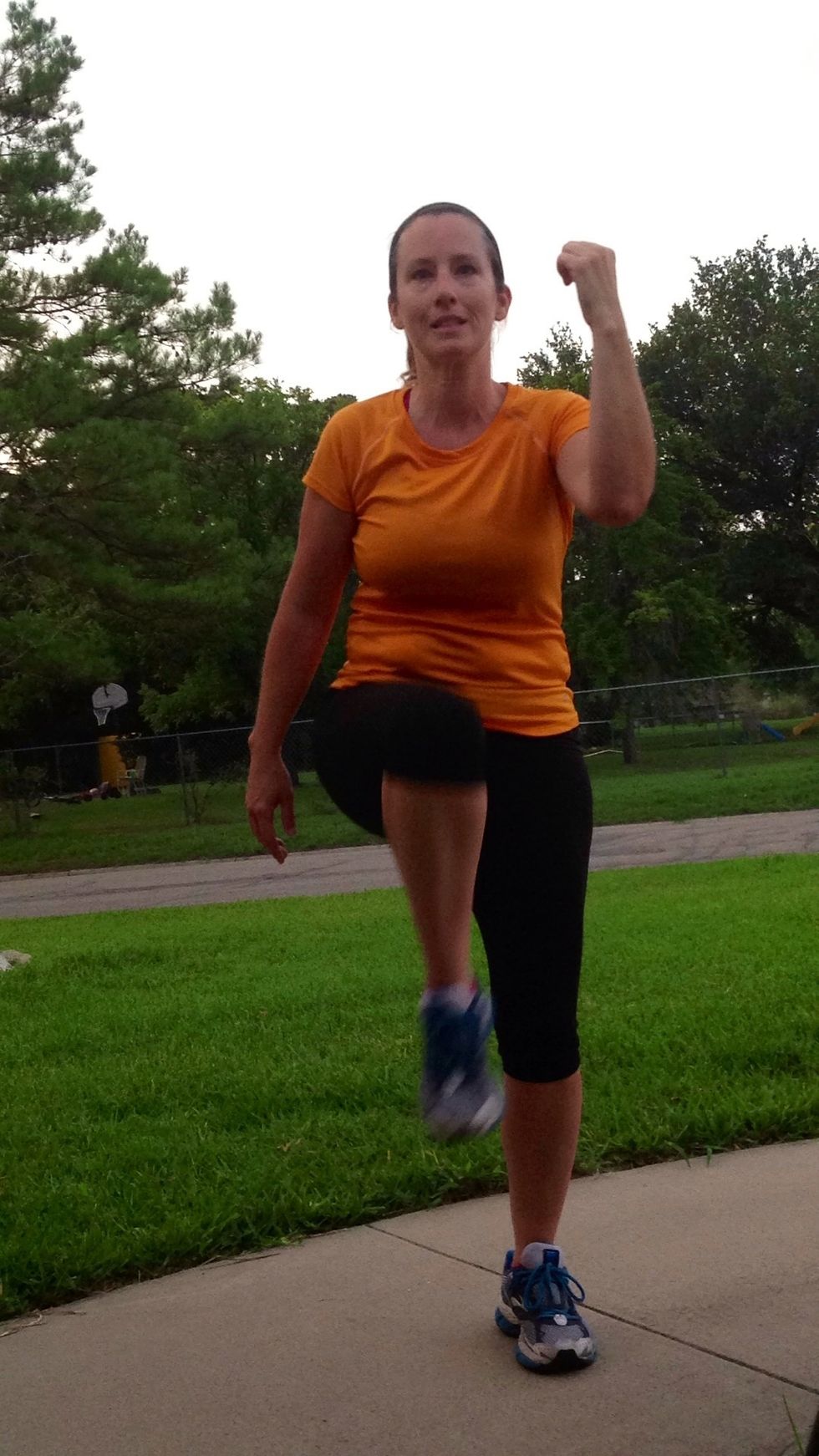 Now stand up lifting one knee.