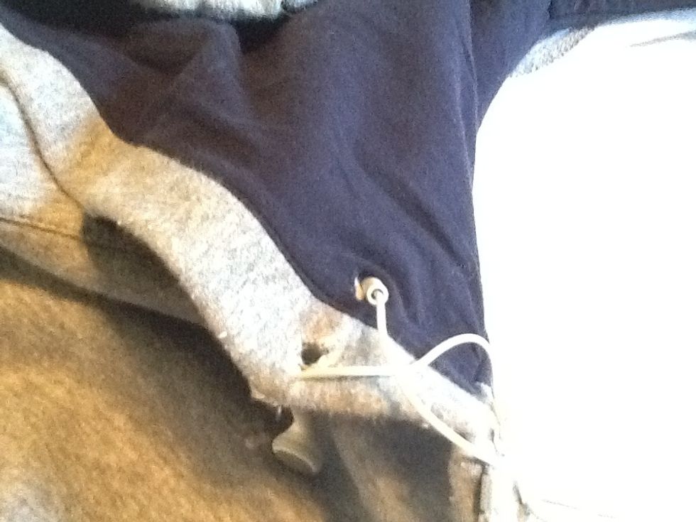 Now start by putting the other headphone through the hole in the roof of the hood towards the other side to do this you will need to kind of rub/push the headphone through to move it