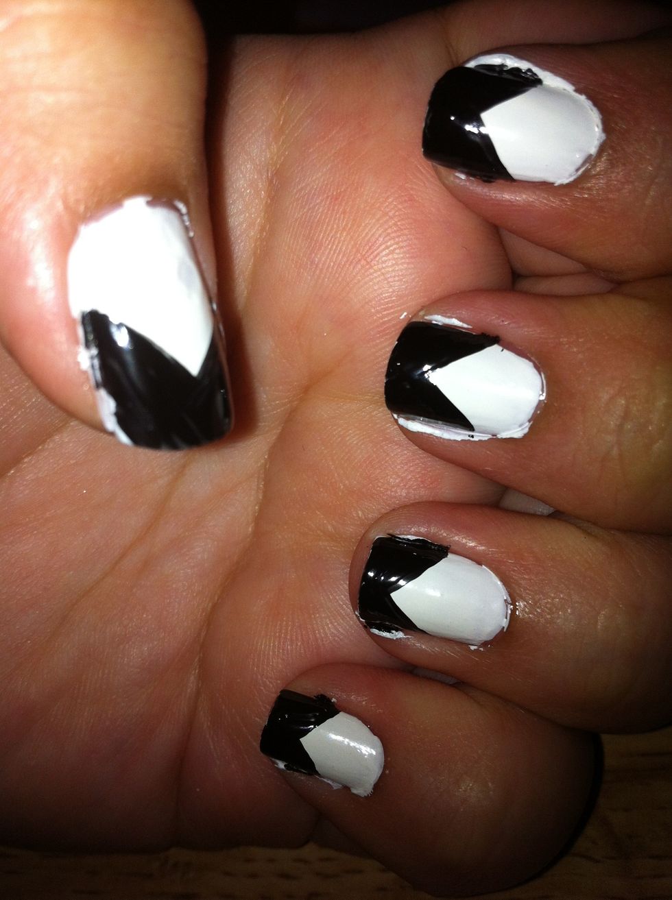 Now start out in the middle of the nail and draw a V and then just fill it in with black polish.You can do this freehand or you can use tape