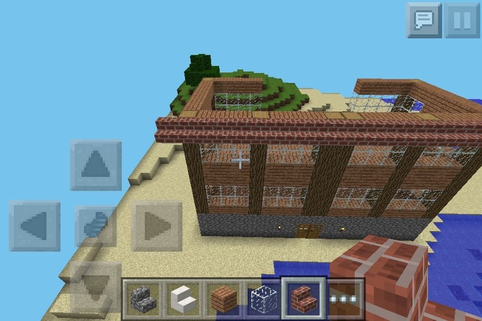 Now start to build the peaked roof. Make sure you start one block down and out from the building. Not just on top. And extend the roof outward a by 1 block at the ends.