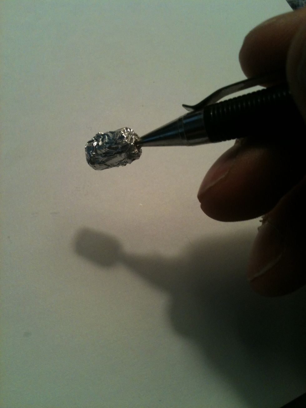Now stick the aluminum covered eraser on the end of the pencil by puncturing it with the "needle" on the tip of the pencil.