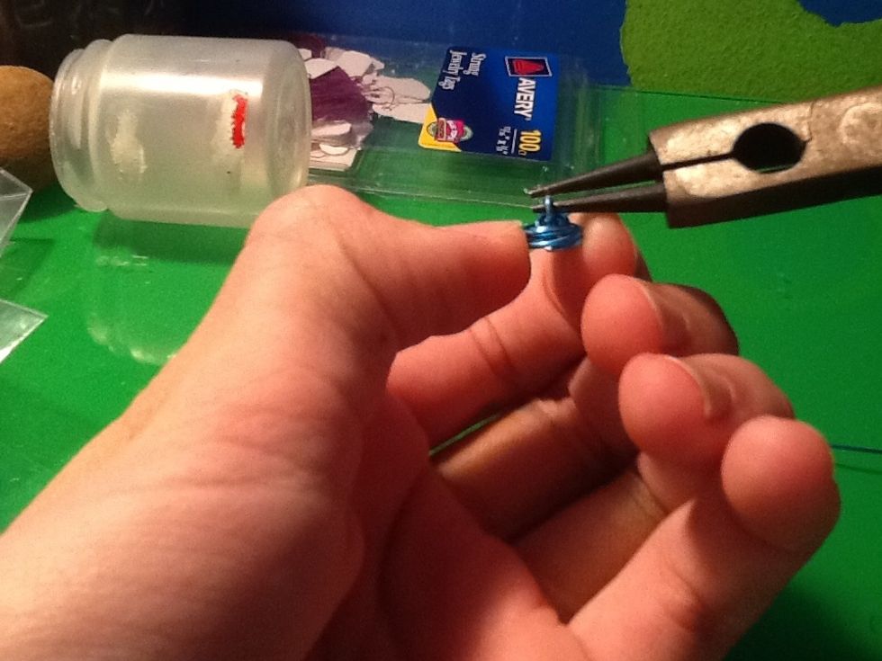 Now stick the nose pliers in the loop and begin to pul the spiral